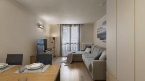 a living room with a couch and a table at Appartamento Acquaseria 310 in Ponte di Legno