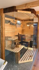 a room with wooden walls and a glass wall at Bergromantik Ferienwohnung Harmonie in Marktschellenberg