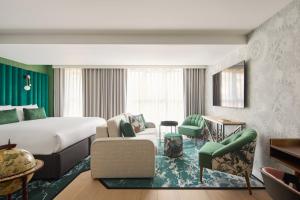 a hotel room with a bed and a living room at Hotel Indigo London Clerkenwell by IHG in London +102 photos
