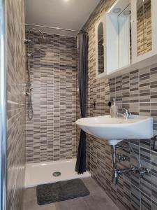 a bathroom with a sink and a shower at Casa Milu in Stazione di Santa Mama +19 photos