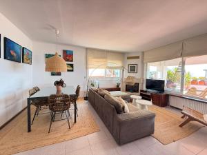 a living room with a couch and a table at Agi El Xalet in Roses +22 photos