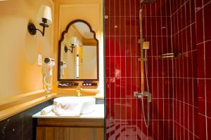 a bathroom with a sink and a shower with a mirror at Maison d'An - Boutique Hotel in Da Lat +51 photos