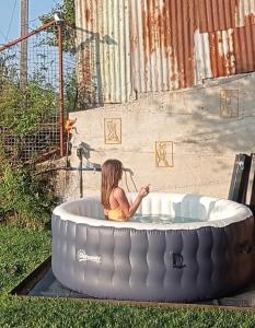 a little girl sitting in a round bath tub at Gerês e Cabreira - Romoa Vintage Guest House in Vieira do Minho