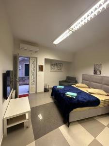 a bedroom with a large bed and a couch at Dubrovnik Inn in Dubrovnik