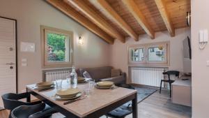 a dining room and living room with a table and chairs at Olgas Chalet in Vione