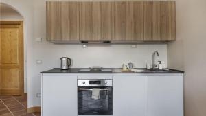 a kitchen with a sink and a stove at InstaView in Ponte di Legno