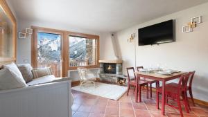 a living room with a table and a fireplace at InstaView in Ponte di Legno +17 photos