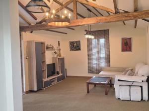 a large living room with a bed and a table at Parque Remonta in Santander