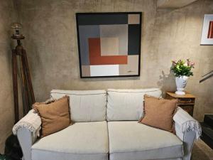 a white couch with pillows in a living room at Boutique holiday home Casa Ars Natura II in Grožnjan