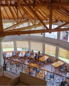 people sitting at tables in a room with windows at Hotel Soleado in Ostende