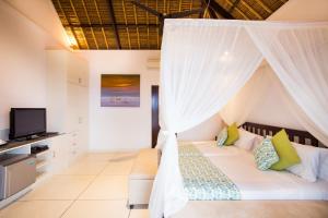 Postel nebo postele na pokoji v ubytování The Point Resort Lembongan