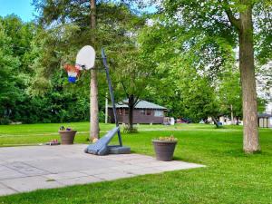 a basketball hoop in a park with at 2-Bedroom - Balsam Lake Cottages Resort #12 in Kawartha Lakes +3 photos