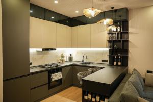 a kitchen with a couch and a stove top oven at Apartment Felix Varla in Kutaisi
