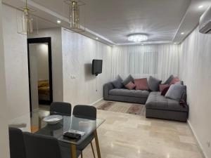 a living room with a couch and a table at CHU Tanger in Tangier +3 photos
