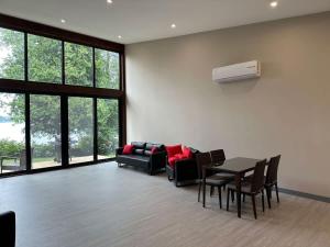 Una sala de estar con un sofá, una mesa y sillas. en 3-bedroom Lakefront Villa #6, en Lakefield