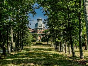 a building in the middle of a park with trees at Country Refuge - Langhe at 60min - Sea at 30min in Carcare