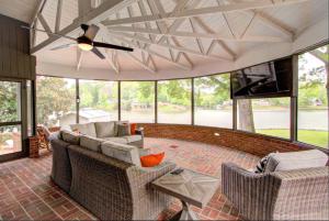 a living room with couches and a ceiling fan at Paradise Point Lake Home in Charlotte
