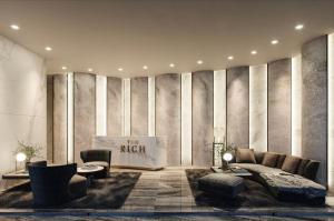a living room with a bed and a couch and chairs at The Rich Rama 9 Luxury Condos in Sathani Ban Hua Mak