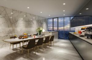 a kitchen and dining room with a table and chairs at The Rich Rama 9 Luxury Condos in Sathani Ban Hua Mak