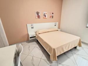 a small room with a bed and a table at Al 211 Rooms in Pizzo