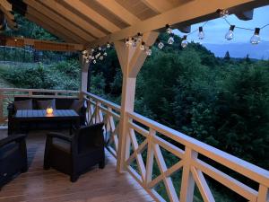 a patio with a table and chairs on a wooden deck at Jutrzenka in Międzybrodzie Kobiernickie