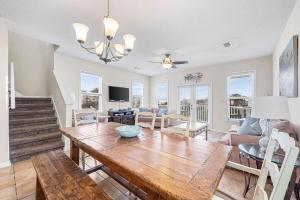 a living room with a table and a couch at Barefoot Breeze,Steps To The Beach ,Pool ,Sleeps 13, Seacrest in Seacrest