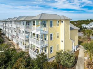 an aerial view of a row of apartment buildings at Barefoot Breeze,Steps To The Beach ,Pool ,Sleeps 13, Seacrest in Seacrest
