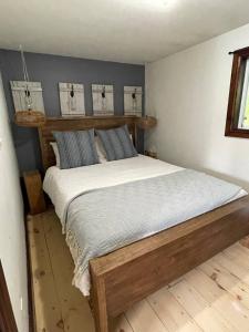a bedroom with a wooden bed in a room at Muskoka Cabana - Sandy beach cottage in Muskoka in Windermere