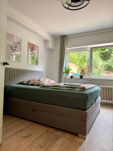 a bedroom with a large bed in front of a window at ausZEITlarn - Apartment in Zeitlarn