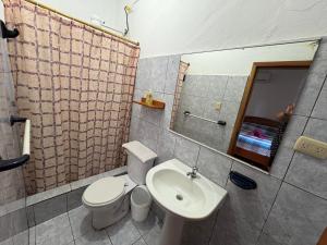 a bathroom with a white toilet and a sink at El Paraiso in Puerto Ayora +36 photos