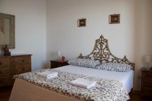 a bedroom with a bed with two towels on it at Sea view apartment, 3 bedrooms, large living room in Piombino