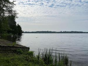 a large body of water with trees in the background at 3-bedroom Lakefront Villa #3 in Lakefield +27 photos