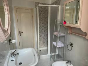 a bathroom with a sink and a toilet and a shower at Sea view apartment, 3 bedrooms, large living room in Piombino +39 photos