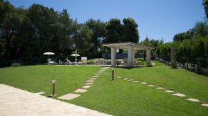 a garden with a gazebo in the grass at Trullandia in Locorotondo