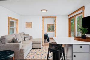 a living room with a couch and a table at Backwoods Cottage on Arbutus Lake in Traverse City