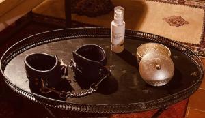 a table with two cups and a bottle on it at LoveRoom Adults-Only in Maillezais