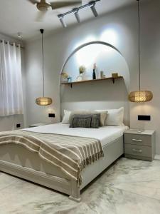 a bedroom with a large bed with an arch above it at Luxury Satvik Stay Room near Ganges with Positive Vibes in Rishīkesh