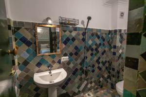 a bathroom with a sink and a mirror at Riad Zara Fez in Fès
