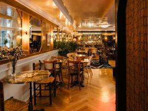a restaurant with tables and chairs and a bar at Hotel du Temps Madrid in Madrid