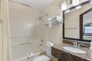 a bathroom with a toilet and a sink and a mirror at Best Western Alpenglo Lodge in Winter Park +31 photos