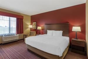 a hotel room with a large bed and a window at Best Western Plus Hudson Hotel & Suites in Hudson +28 photos