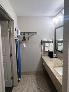 a bathroom with a sink and a mirror at SureStay Plus by Best Western Alamogordo White Sands in Alamogordo +12 photos