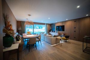 a living room with a couch and a table at Stella Alpina Chalet in Madonna di Campiglio