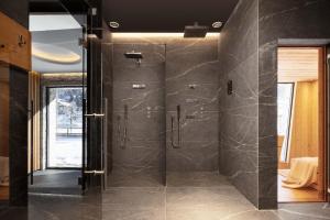 a bathroom with a shower with a glass door at Stella Alpina Chalet in Madonna di Campiglio +27 photos