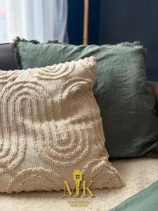 a pillow sitting on top of a bed with pillows at Le Bleuet Boulevard de la Rochelle, centre-ville in Bar-le-Duc +25 photos