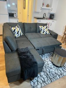 a living room with a gray couch with pillows at One bedroom Apt in Riverview in Riverview +31 photos