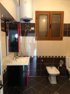a bathroom with a sink and a toilet at Vila Mehalla in Arape-Rashbulli