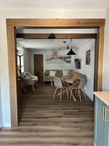 a dining room and living room with a table and chairs at El Refugio de los Corrales in San Mateo
