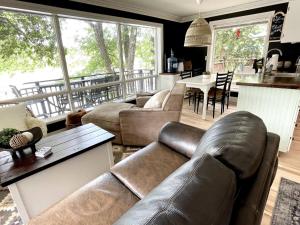 a living room with a couch and a table at The Muskoka Nest in Utterson