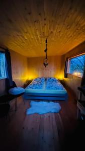 a bedroom with a large bed in a room at Tiny house Modřínka in Nadějkov